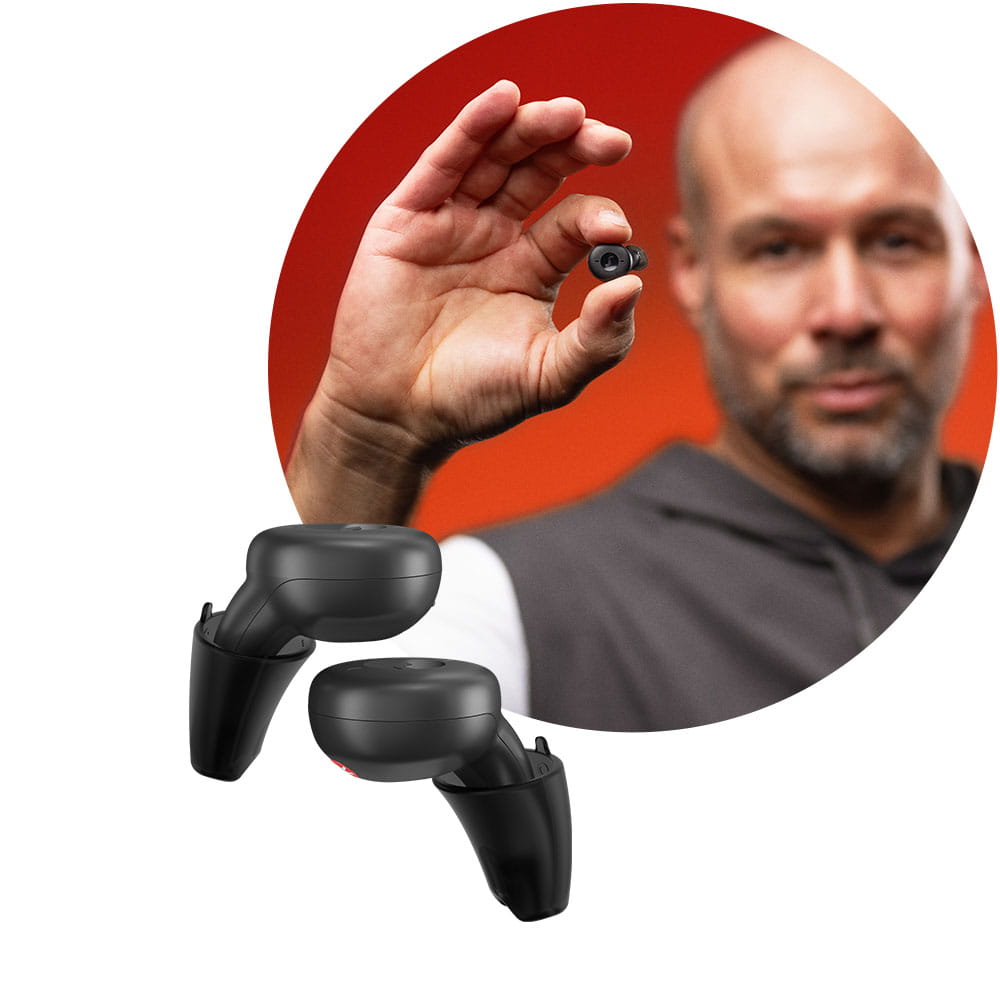 Man holding Active IX hearing aid in earbud design