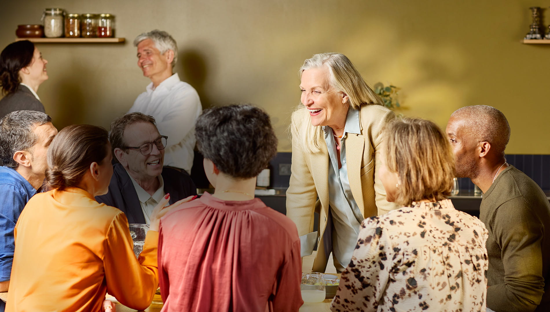 Group of people sitting around a table in coversation