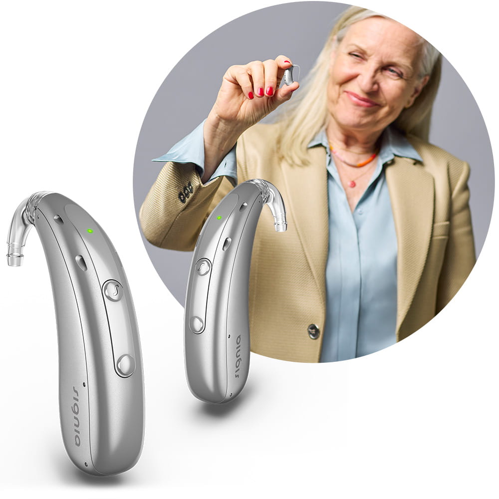 Woman holding a Motion Charge&Go IX hearing aid between fingers