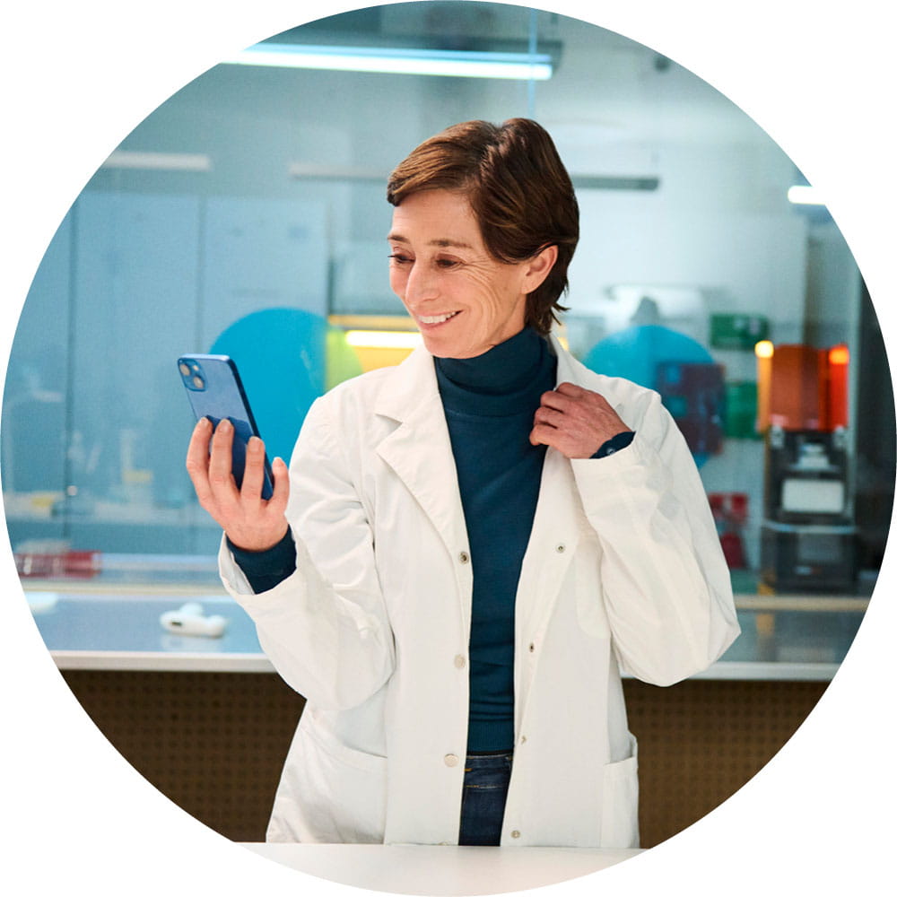 Woman in laboratory holding smartphone