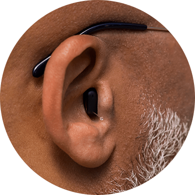 Professional man wearing Silk Charge&Go IX hearing aids in the ear
