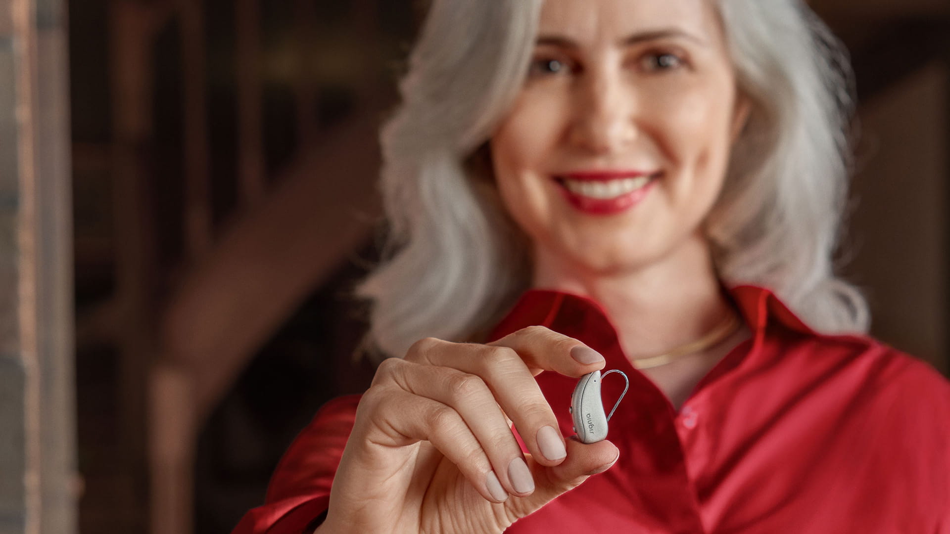 Women holding hearing aid Pure C&G MaX