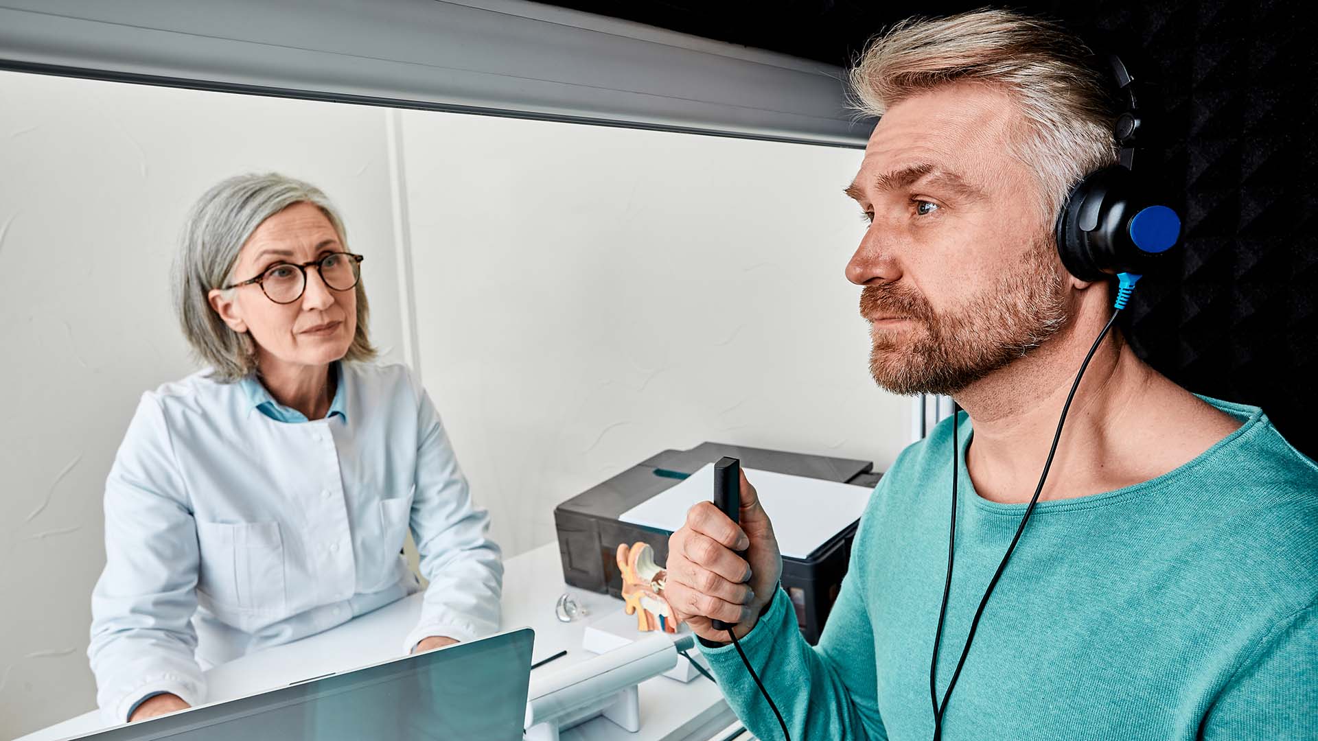 Man getting professional hearing test with an audiologist
