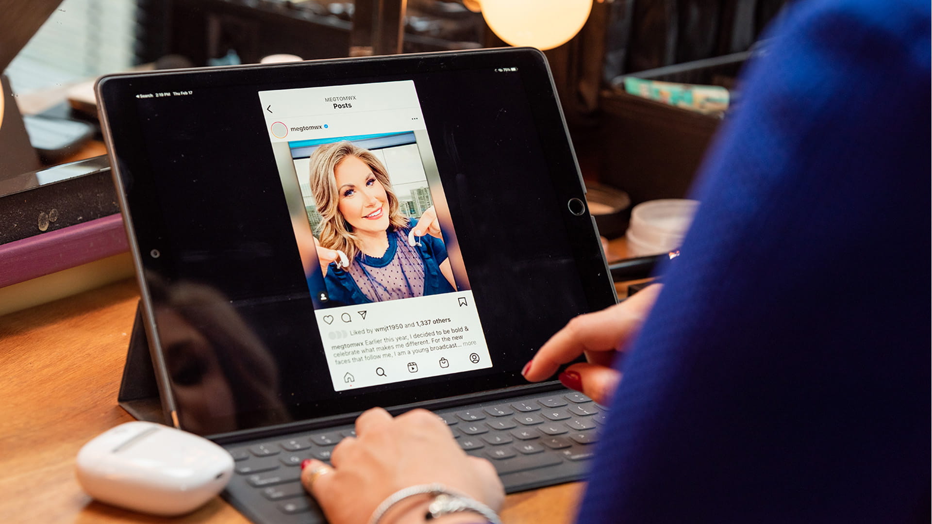 Meaghan Thomas, Broadcast Meteorologist, looking at her post about wearing Signia hearing aids